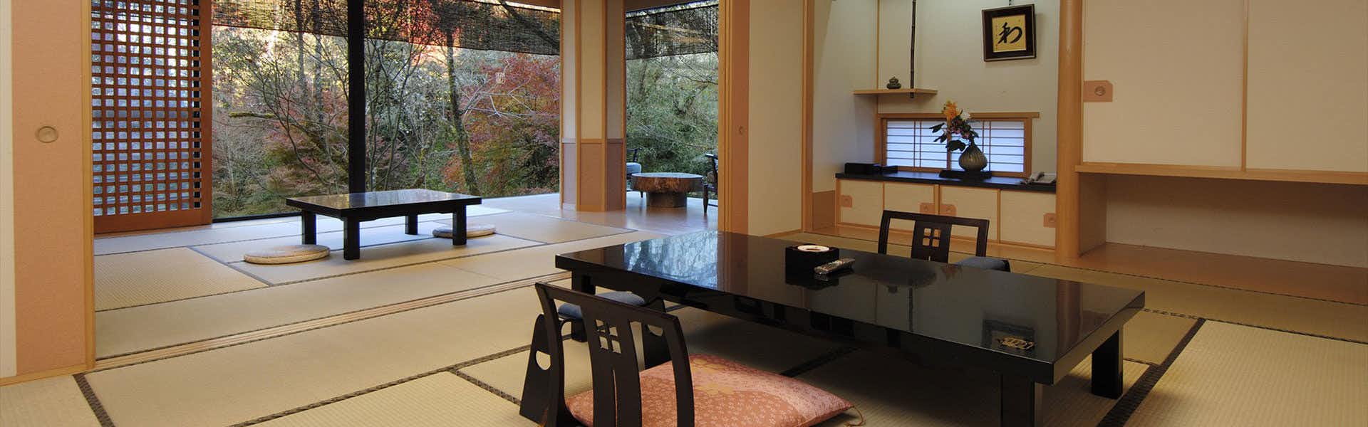 Gio Onsen Ryosan with a traditional tatami room with low table and garden windows.