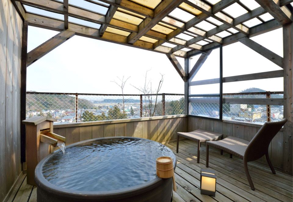 An outdoor bath on a covered terrace.