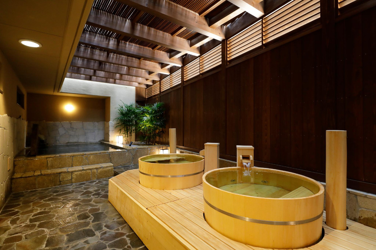 Wood-paneled bath with round tubs.