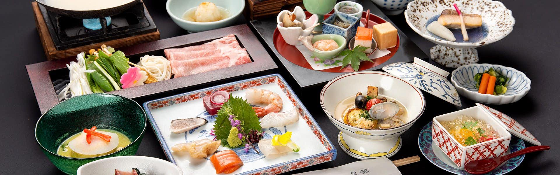 Hotel Kurobe with a generous Japanese dinner arranged across black trays.