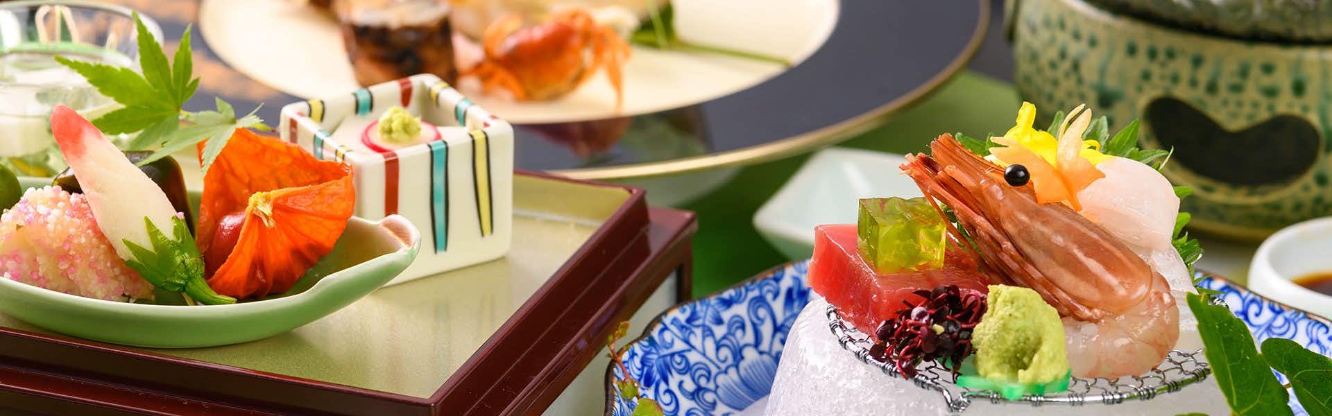 Kasuga Hotel with colorful sashimi arranged on blue and white ceramic plates.