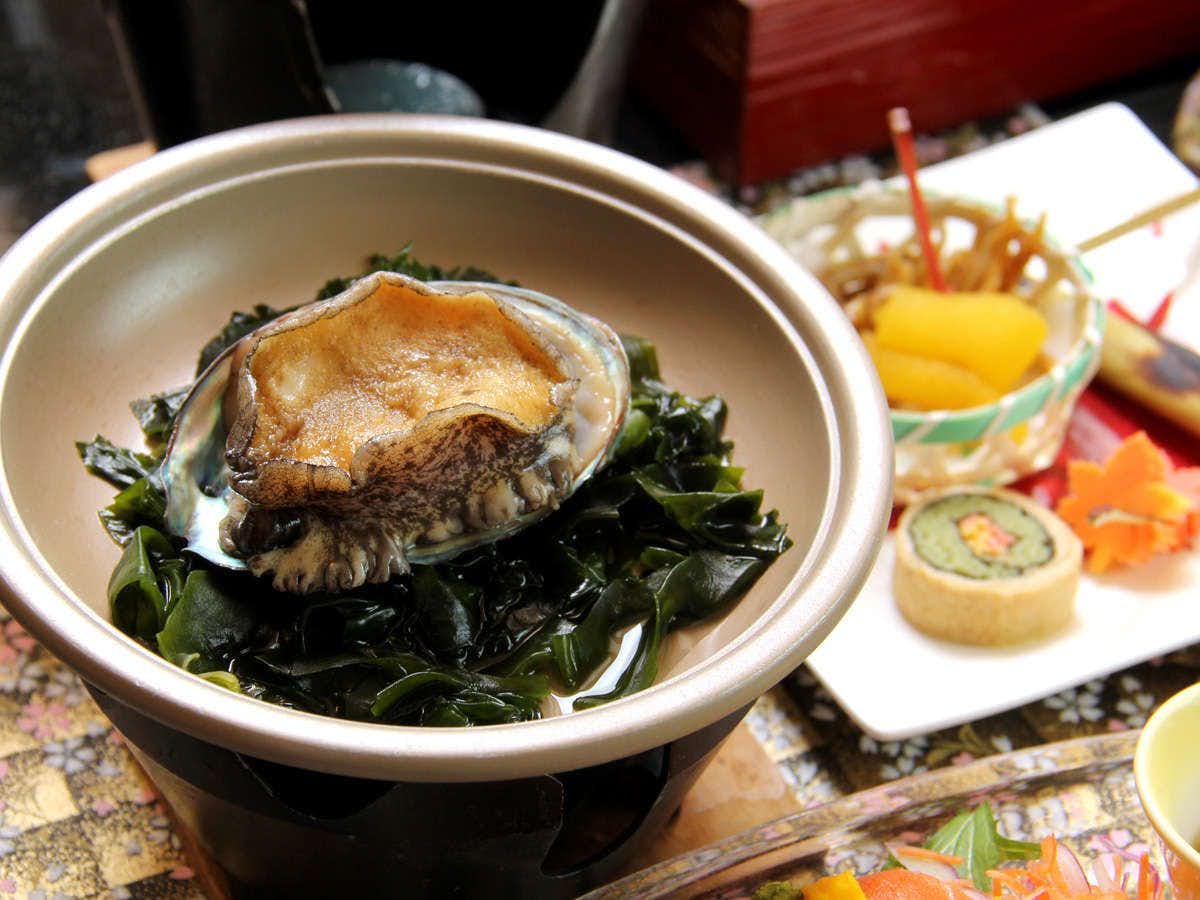 Ryumontei Chiba Ryokan with fresh abalone presented with citrus and seasonal garnishes.