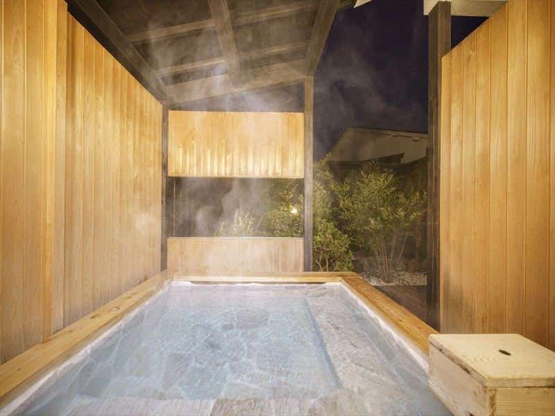 Yufuin Ryokan Seikouen steaming rectangular wood bath open to the night air