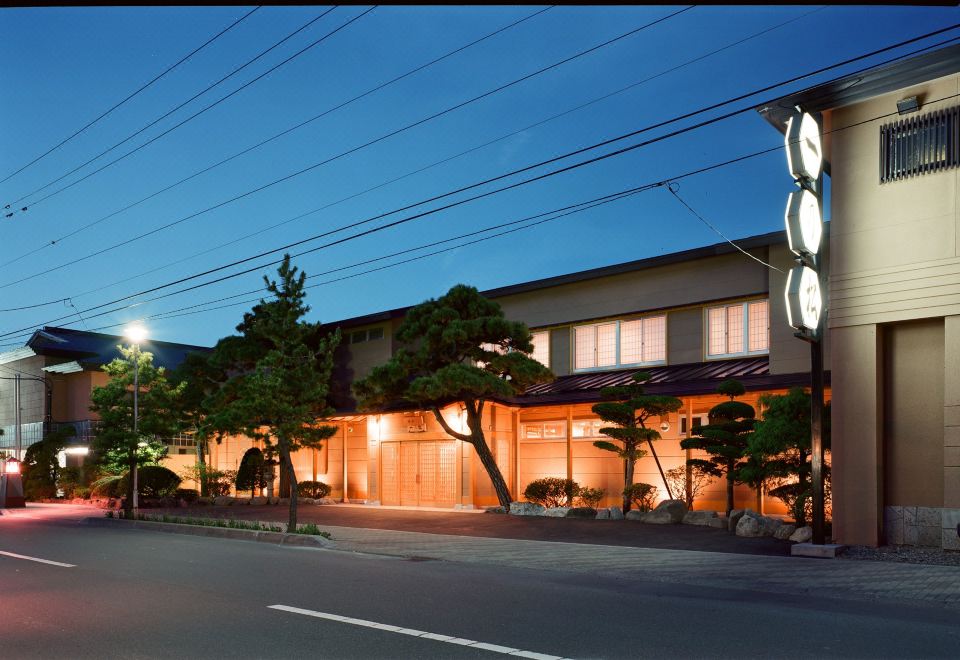 The ryokan exterior at dusk.