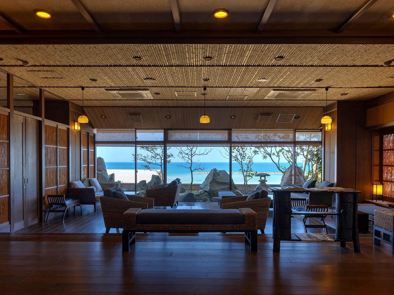 Sunset Romance Ichibokan with a timber lounge overlooking the broad sandy beach.