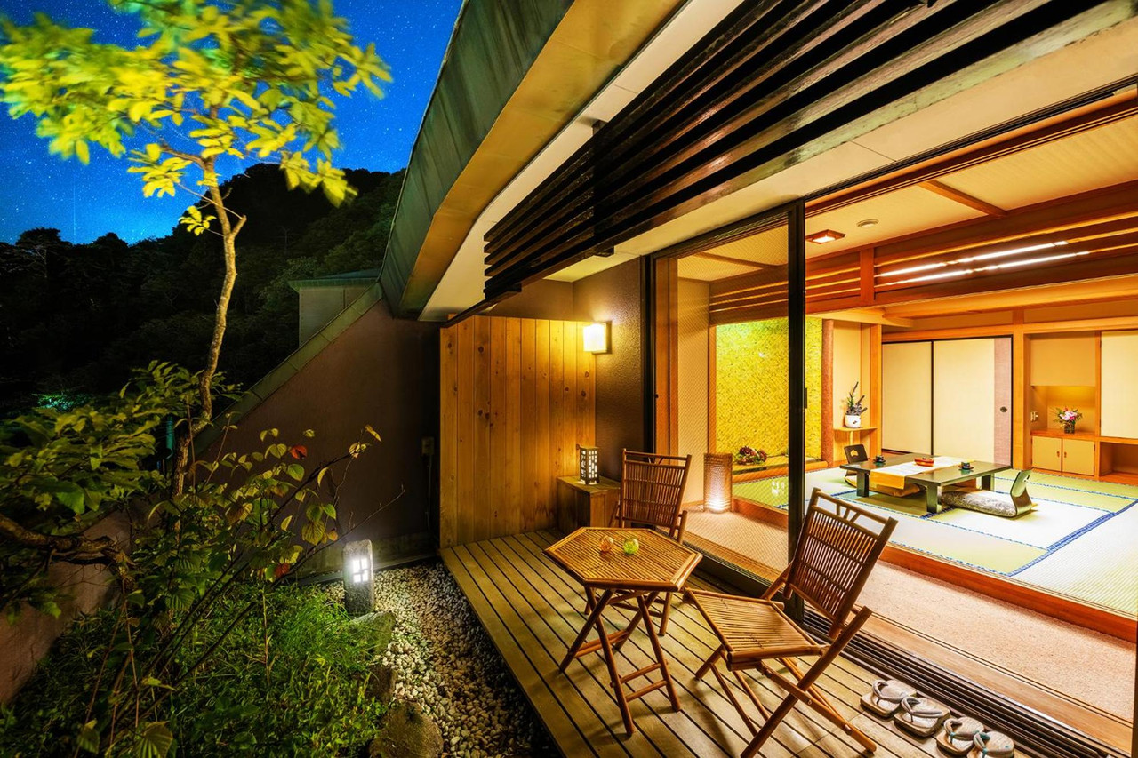 A traditional entrance faces a landscaped rock garden.