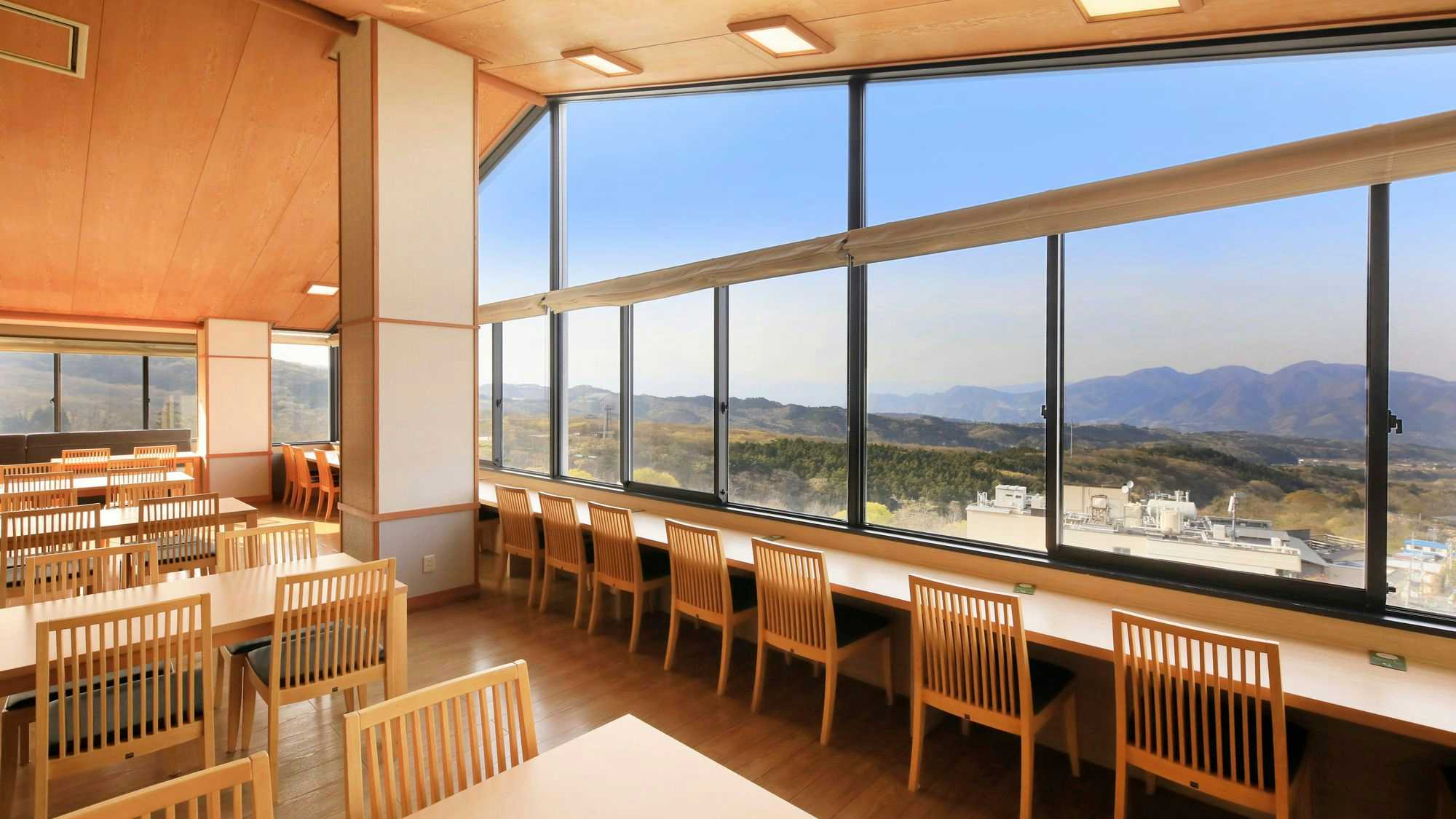 Moriaki Ryokan with a panoramic dining room with timber chairs and mountain views.