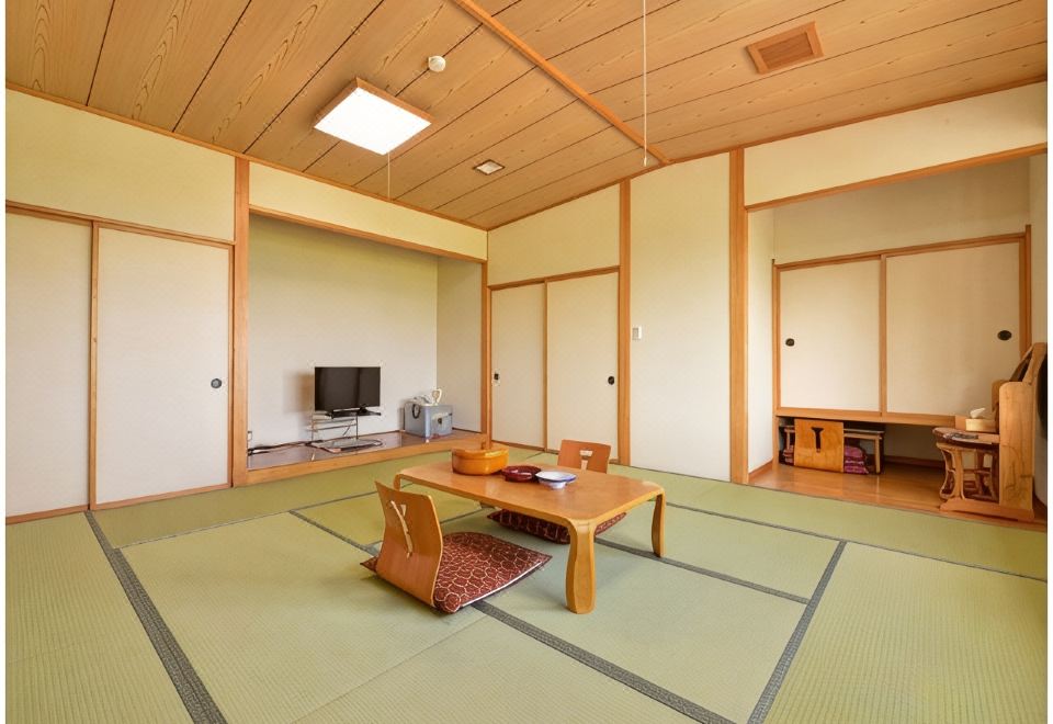 Tatami room with a low table and television.