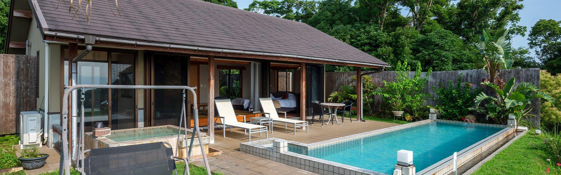 Hot Spring Water Pool & Private Open-Air Bath  YURIAN with a private villa opening toward a rectangular garden pool.