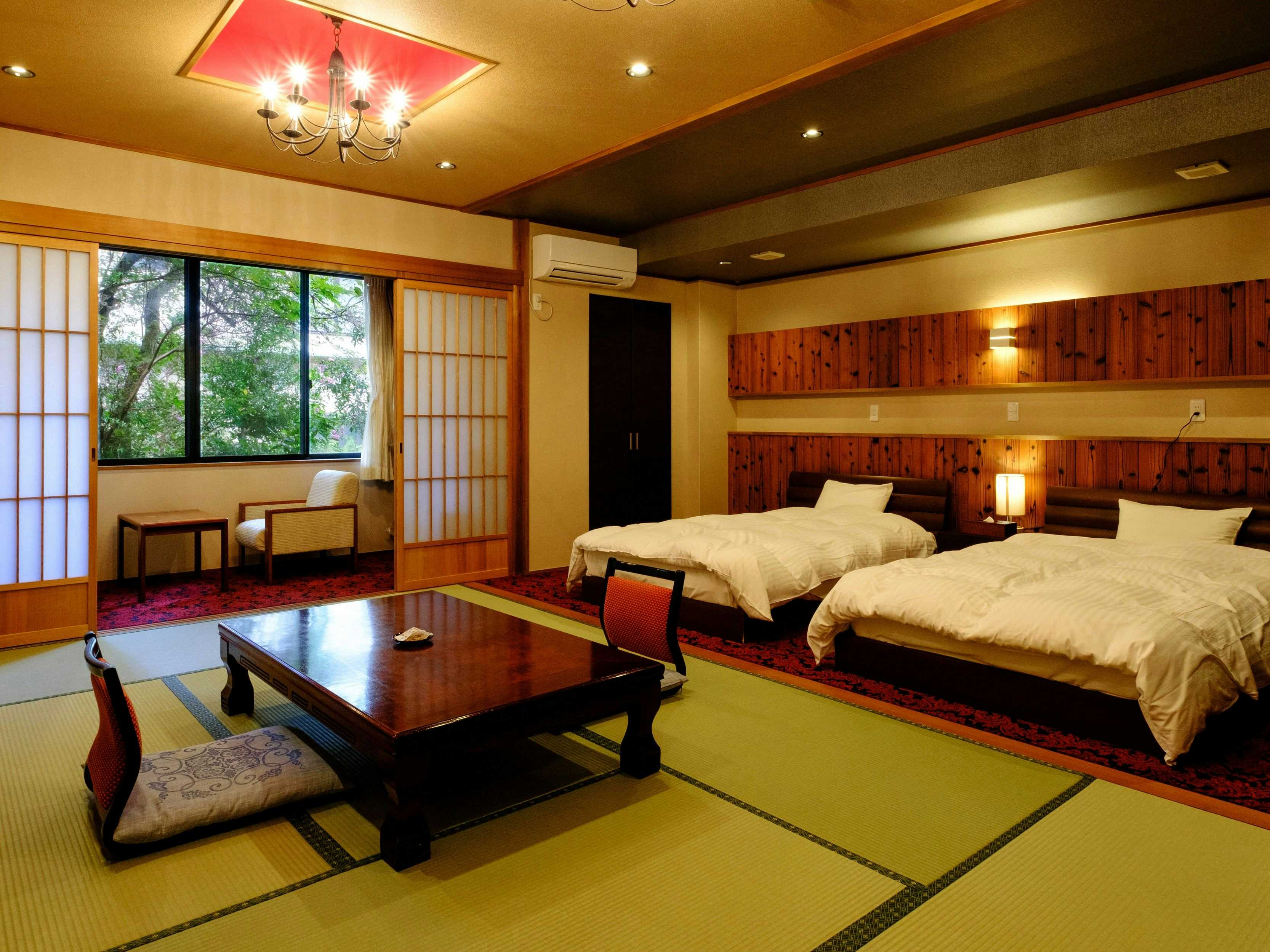 Misasa Onsen Kouraku with a spacious tatami room with twin beds and low table.