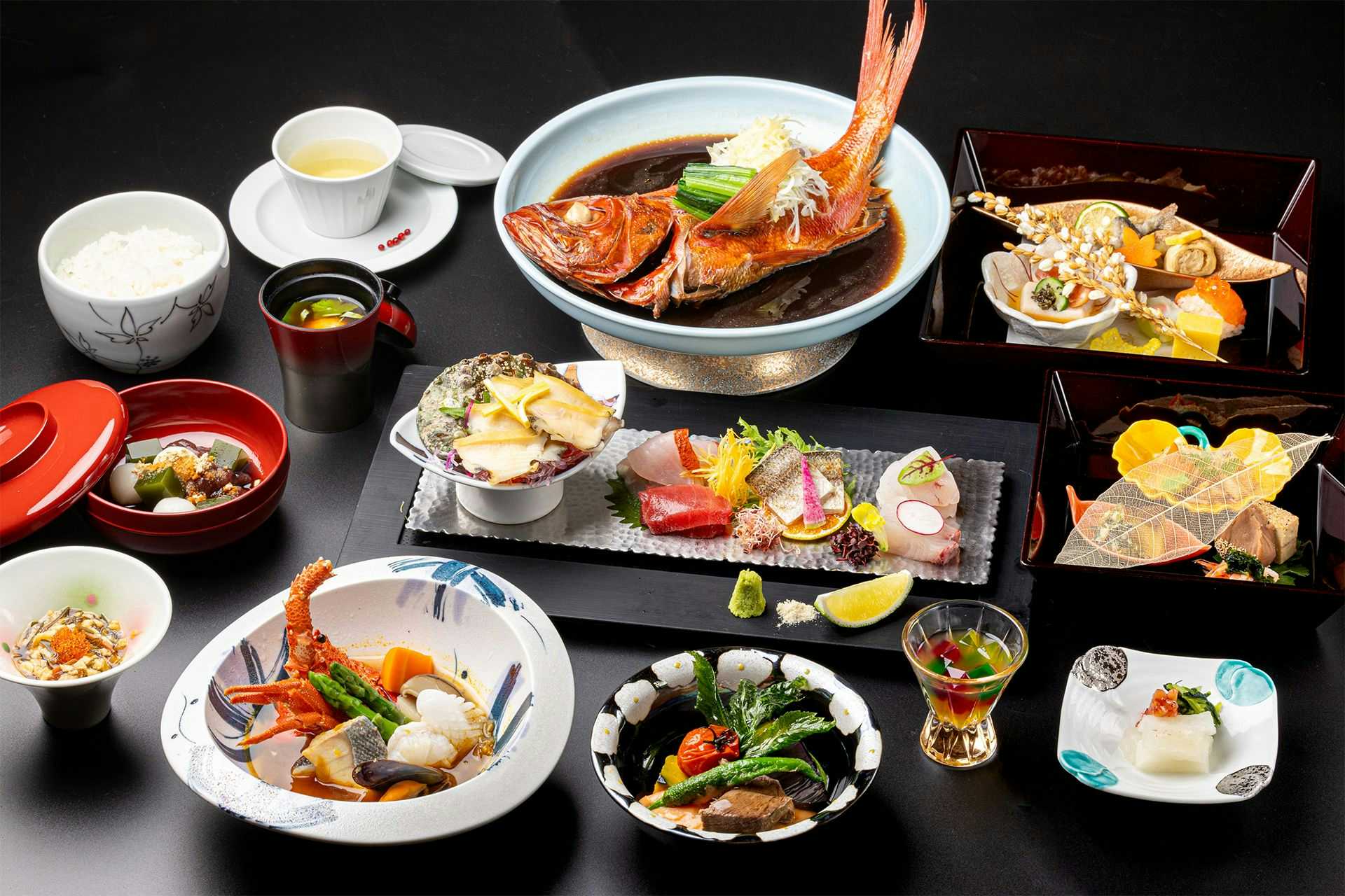 Atagawa Prince Hotel with a Japanese dinner arranged across dark plates and ceramic bowls.