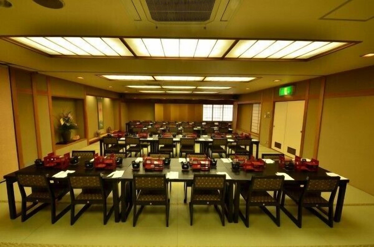 Large dining hall with rows of tables.