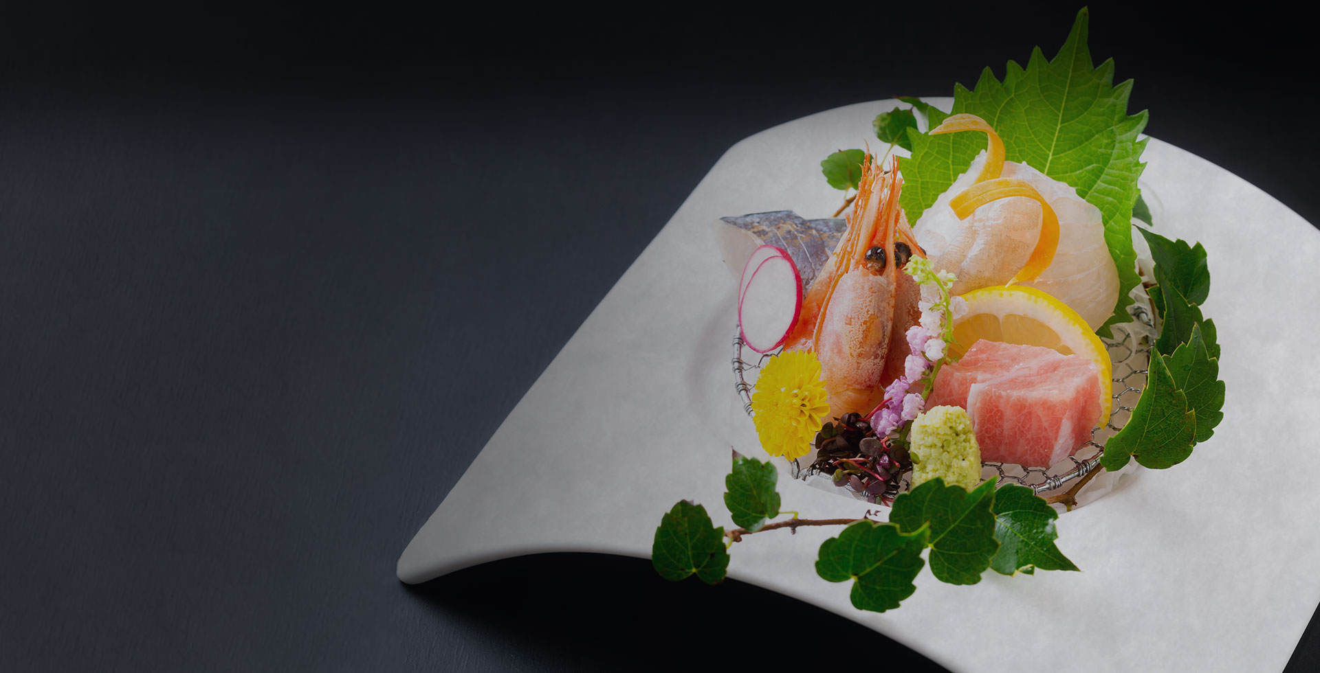 Sashimi presented on a sculptural plate.