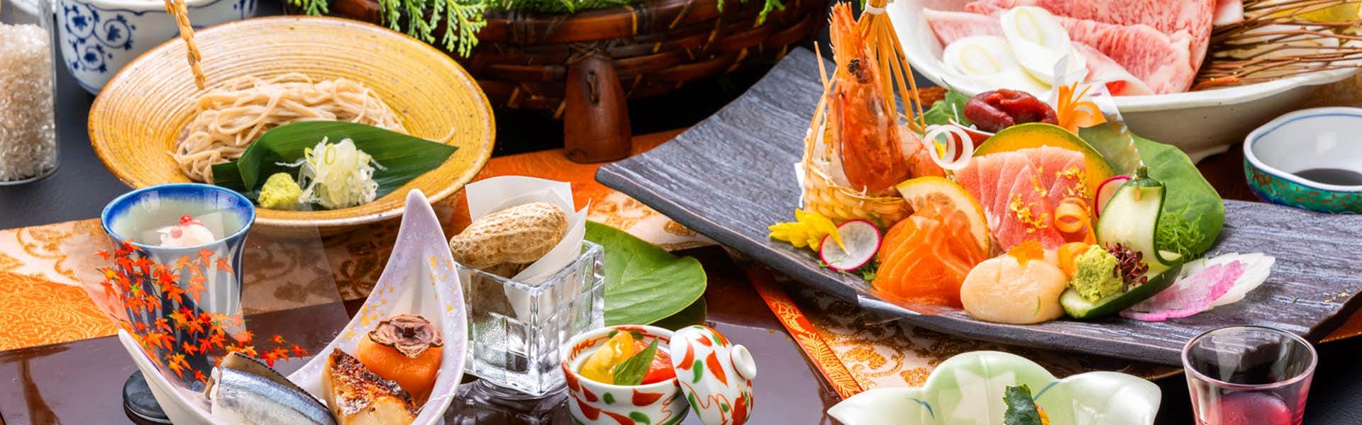 Hirugami Onsen Shiki no Ori Hanaya with a colorful kaiseki dinner arranged around sashimi and vegetables.