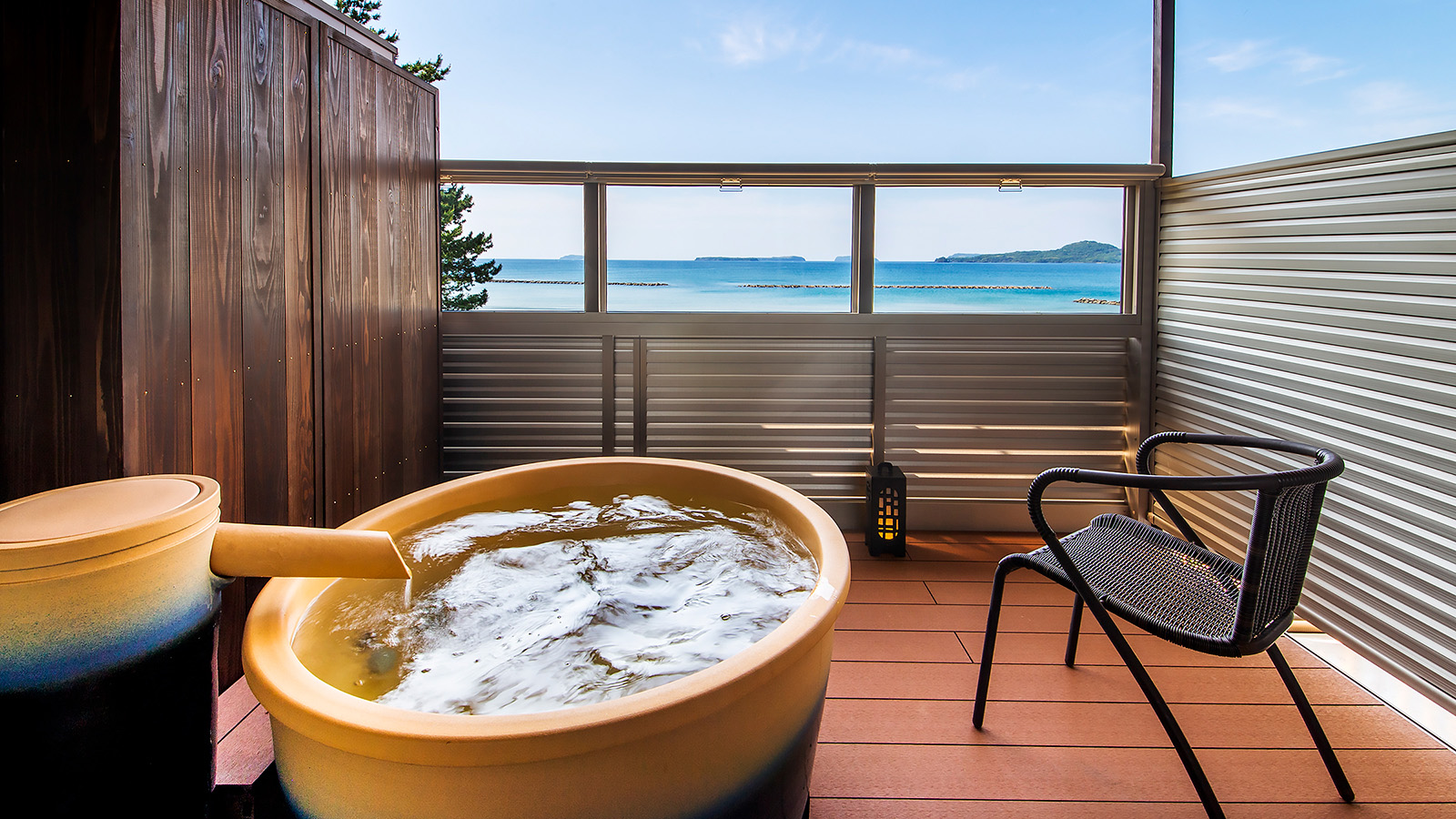 Open-air soaking tub with an ocean view.