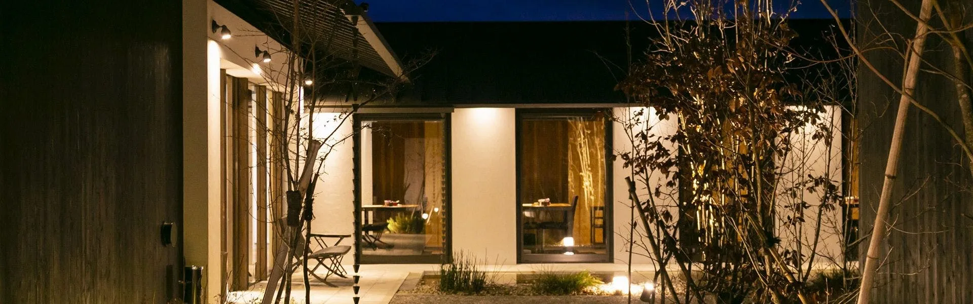 Yufuin Rokka cottage lit from within on a still Kyushu night