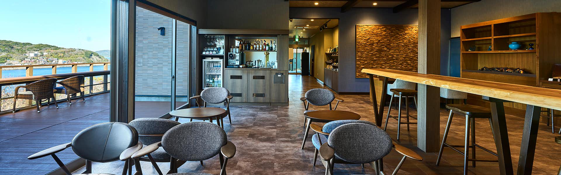 Kisara Villa Toki with a contemporary lounge bar with curved gray seating.