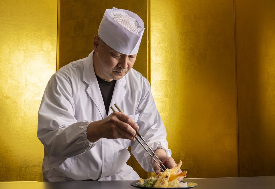 Chef preparing food in a kitchen.