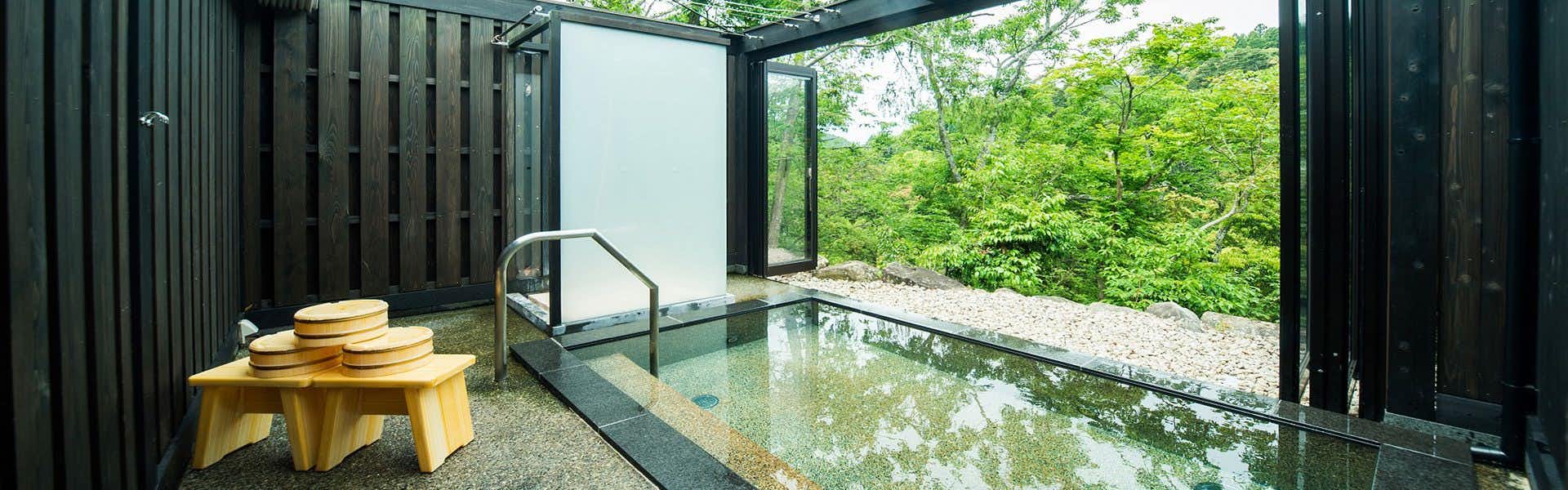 Momijiya Main Building with a bright indoor bath framed by dark timber walls.