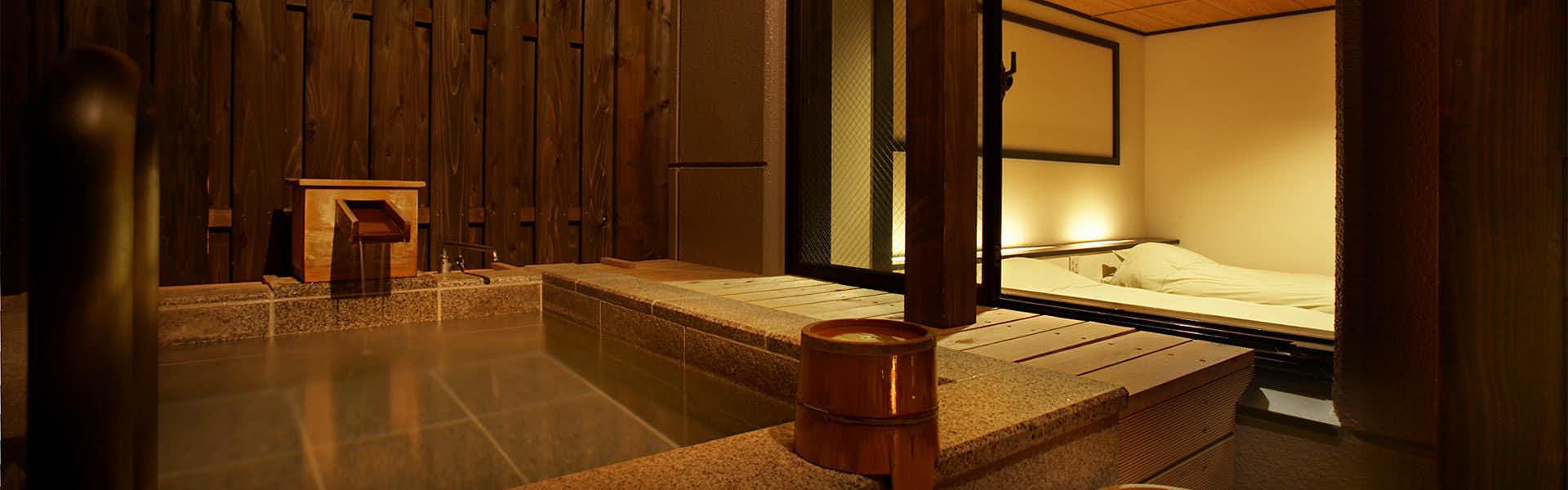 Echigo Yuzawa HATAGO Isen with a private stone bath beside a warm sleeping alcove.