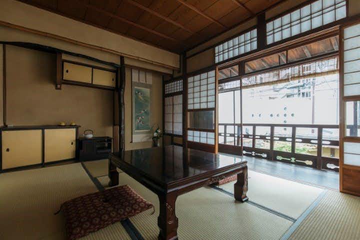 Toshiharu Ryokan with an adjoining tatami room with sliding panels and garden light.