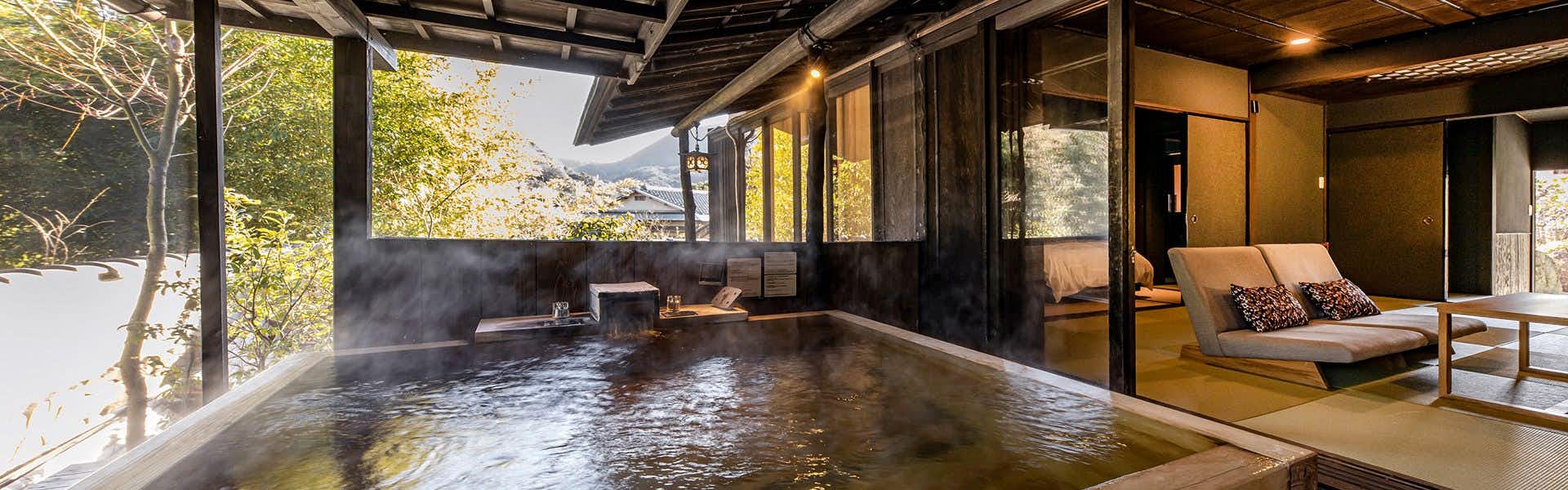 Ishinoya Izunagaoka with a tranquil indoor bath overlooking a private garden.