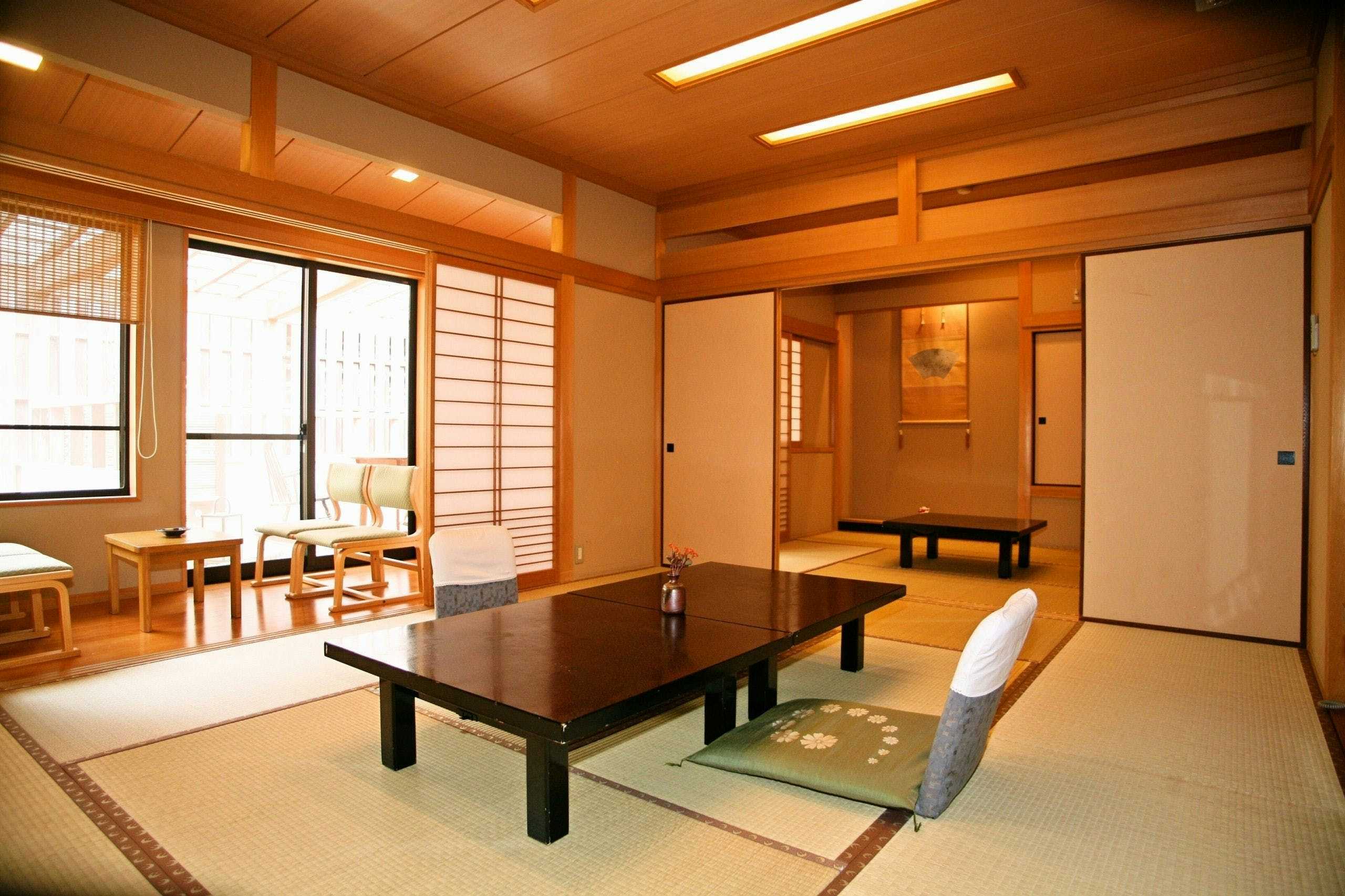 Yunokura Tsuruya with this scene, where a bright tatami room centers a low black table beside shoji screens.