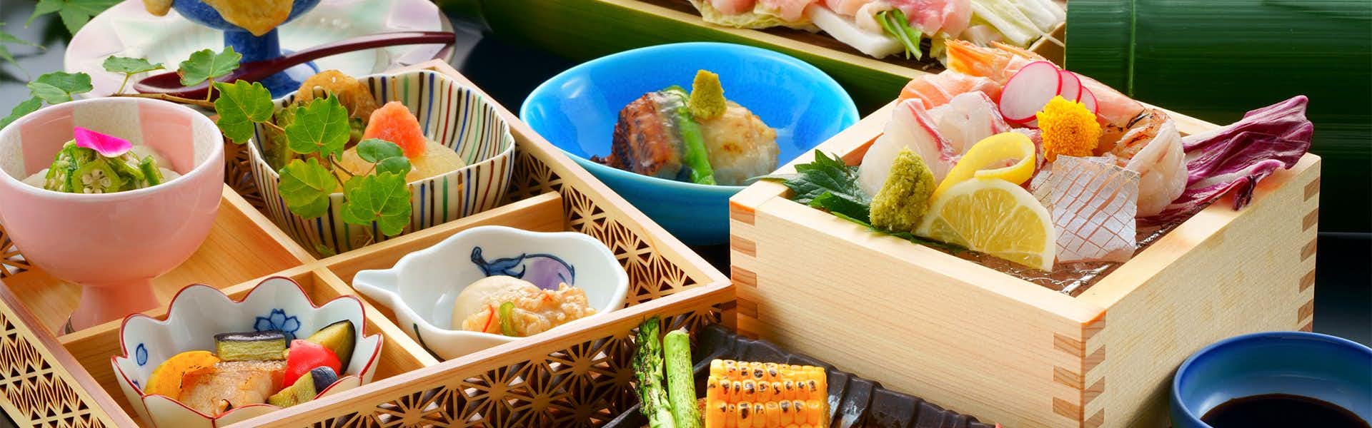 Ureshino Oyado Kujyaku: A colorful Japanese dinner arranged inside timber boxes.