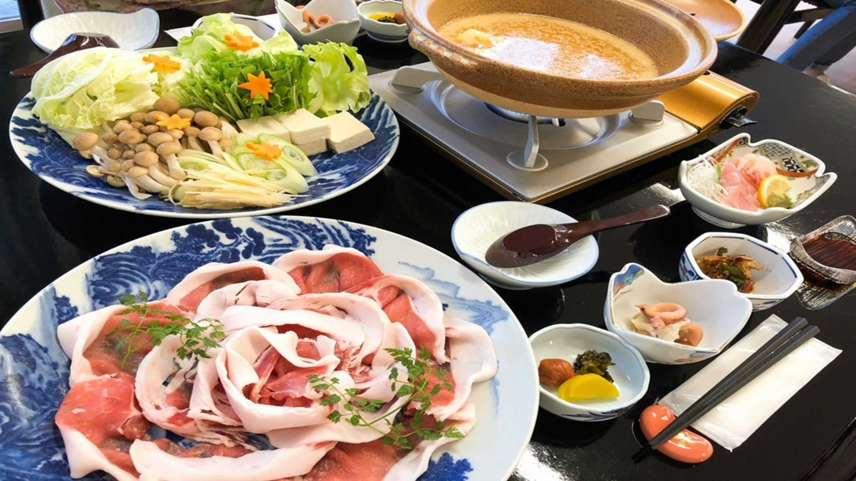 Hotel Sunset Susami with a generous hotpot meal with pork and fresh vegetables.