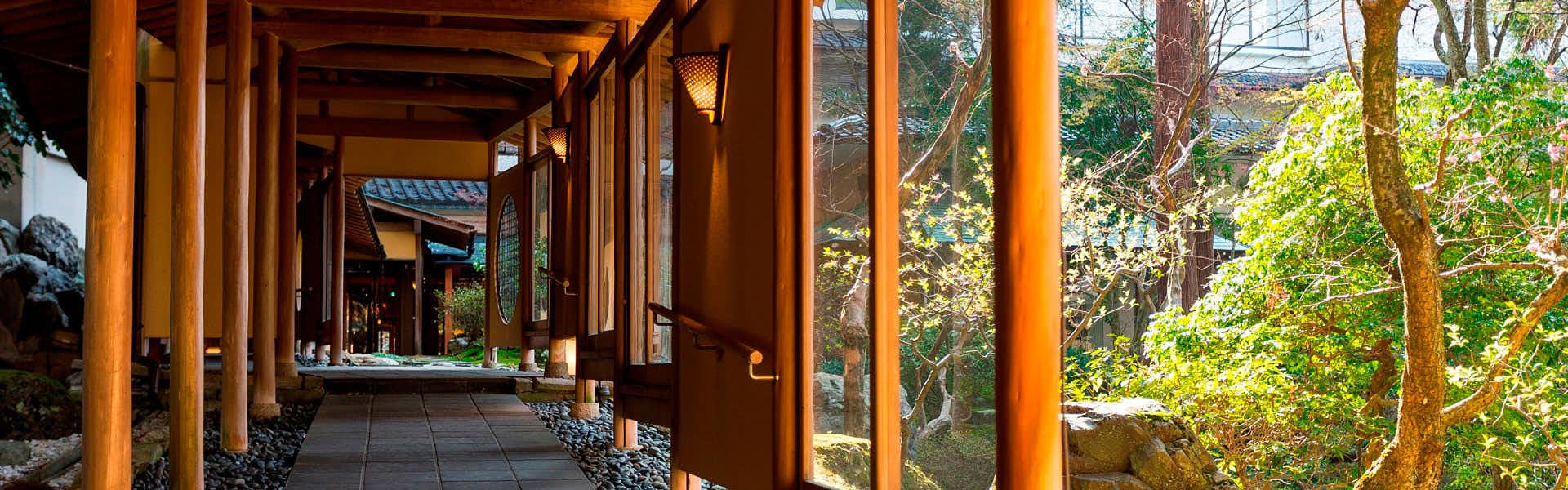Mori no Sumika Resort & Spa with a covered timber corridor overlooking forest greenery.