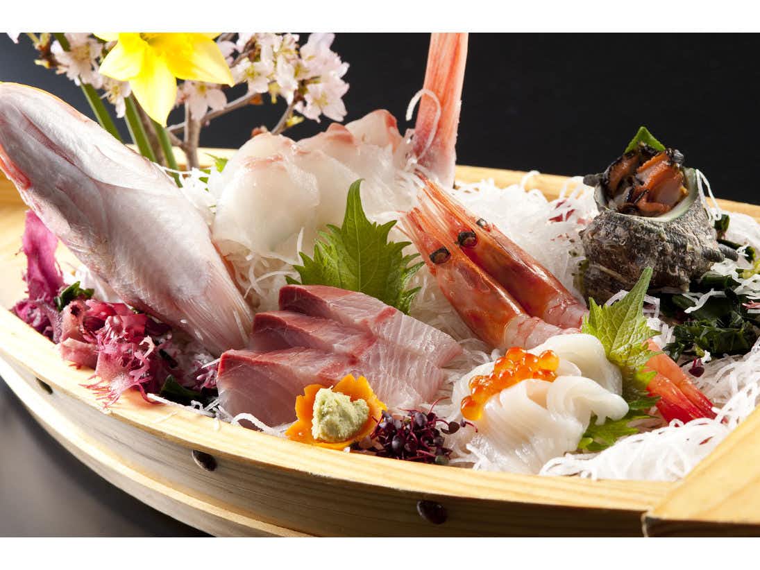 Awara Onsen Seiryukaku with a generous sashimi platter presented with shrimp and seasonal garnish.