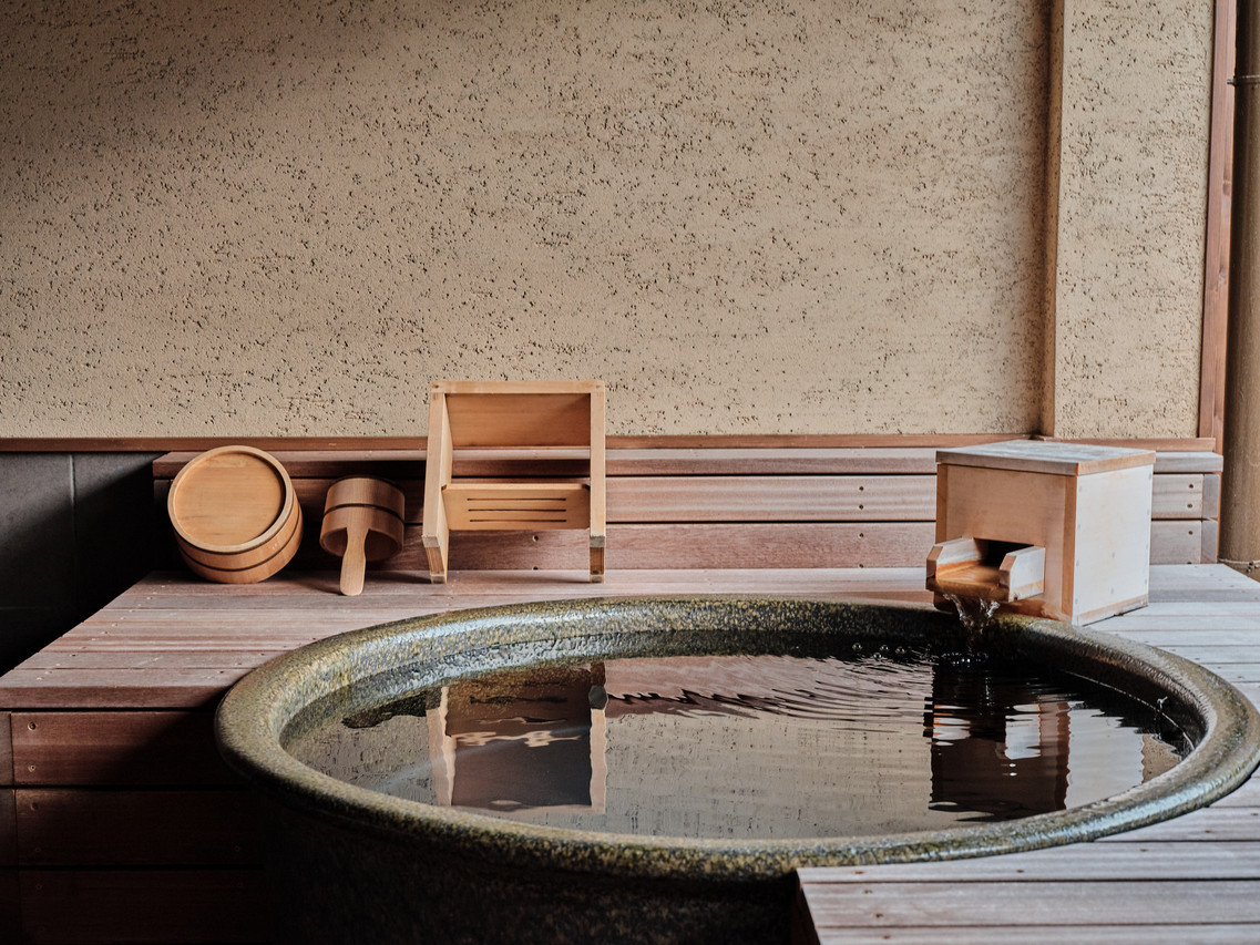 A wooden bath beside a mountain view.