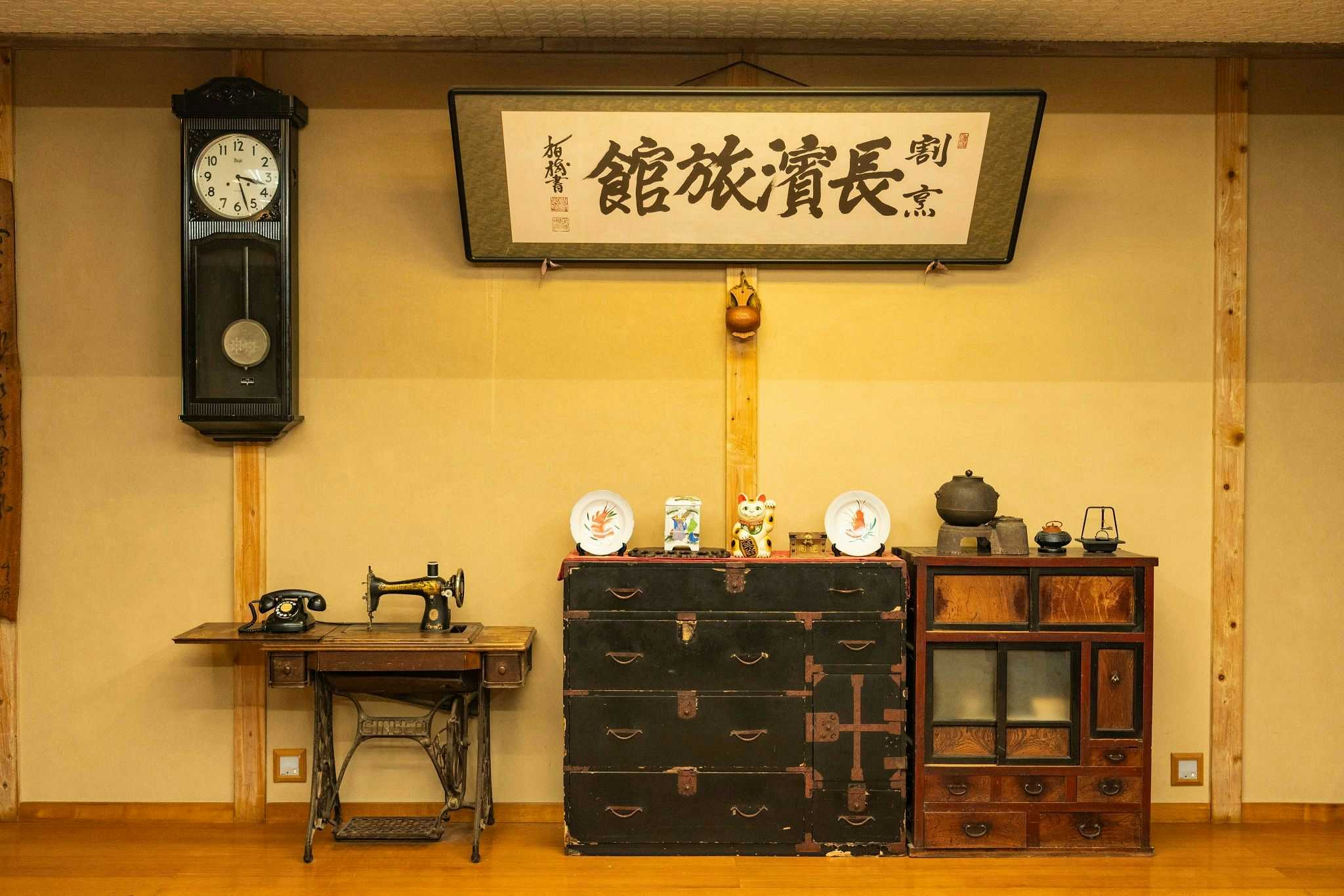 Kappo Nagahama Ryokan with a lake-view guest room with table and simple chairs.