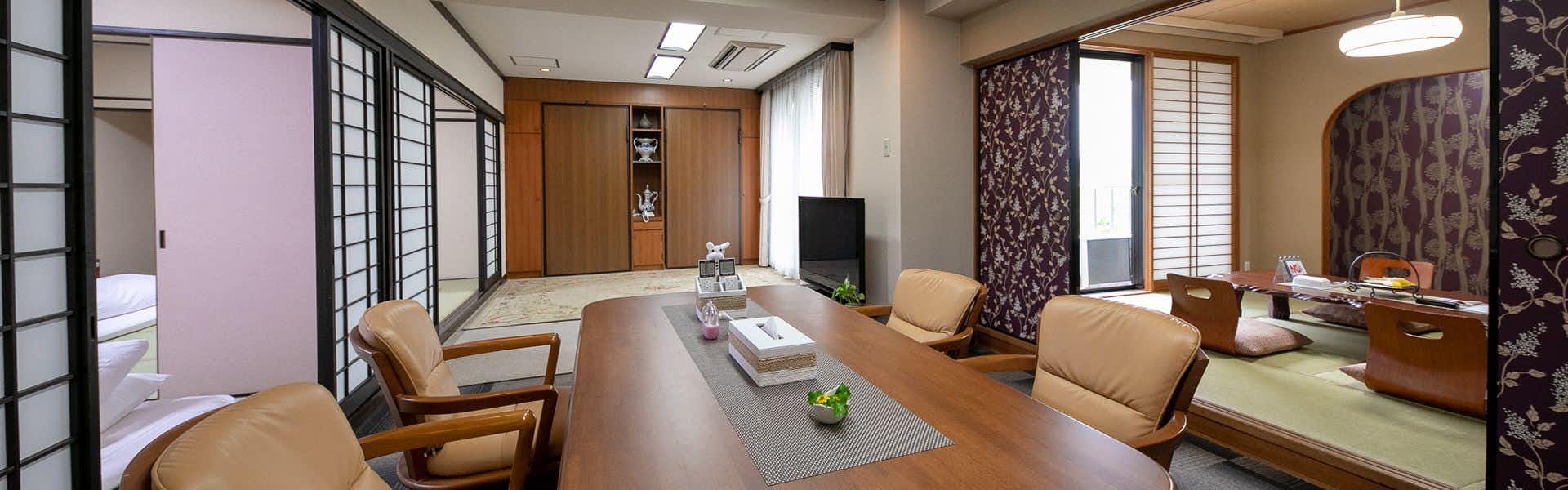 Yufuin Kahori no Sato Hanamura with a modern tatami room with low table and cushioned chairs.