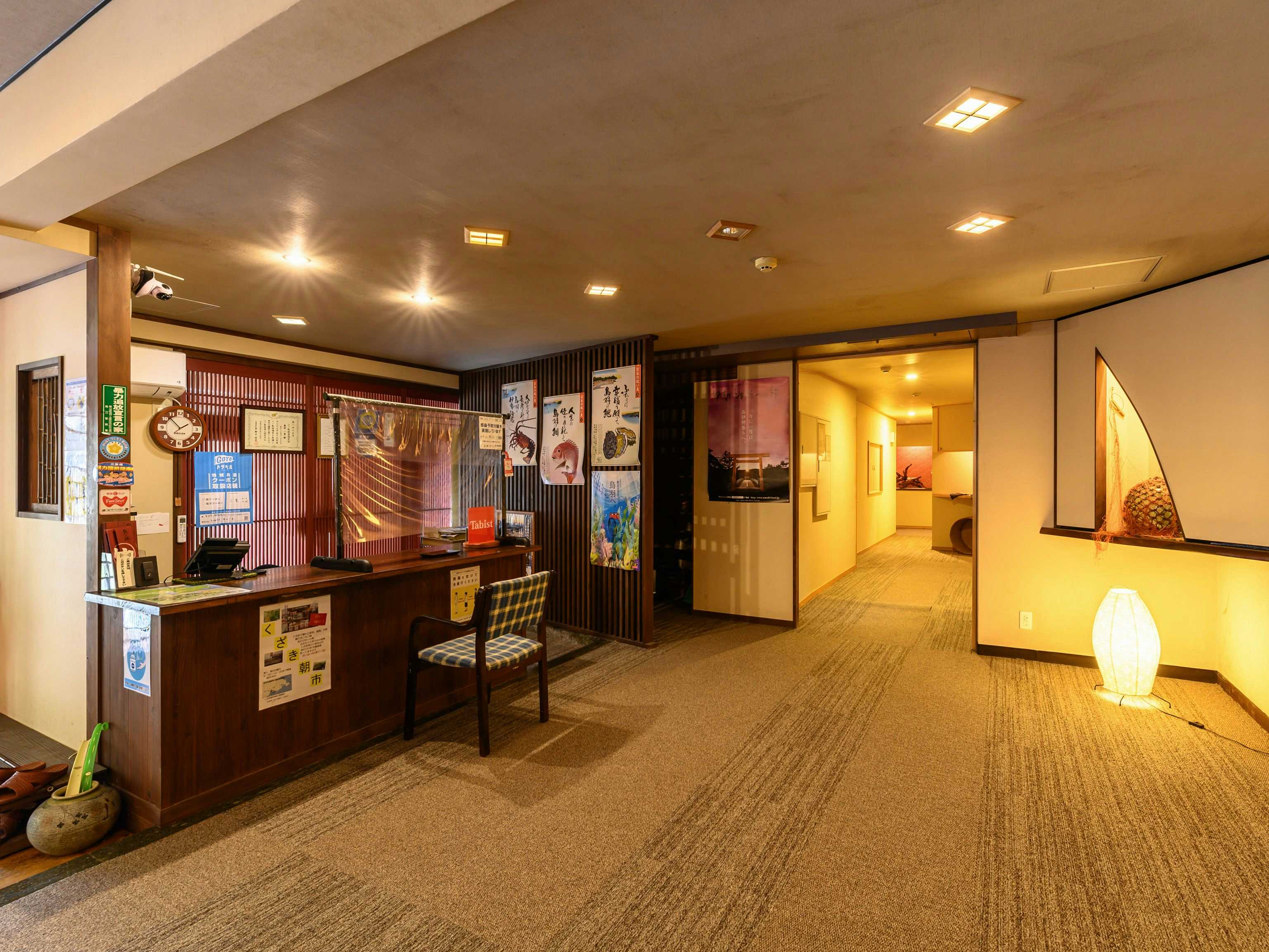 Fish Inn Marusen with a bright lobby corridor with reception desk and patterned screens.
