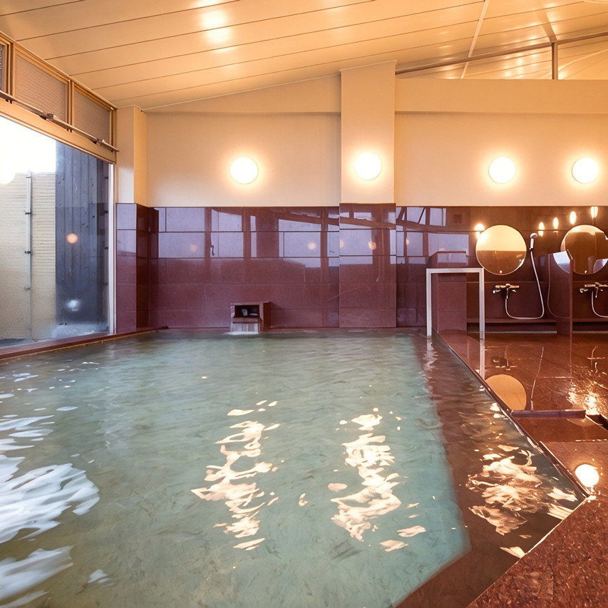 A view across an indoor bath toward the washing area.