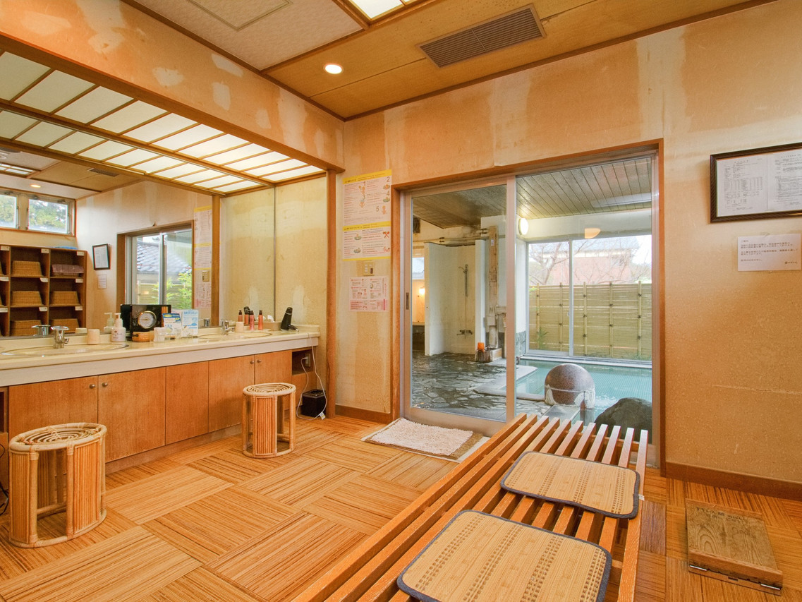 A wooden reception area includes a counter and entry seating.