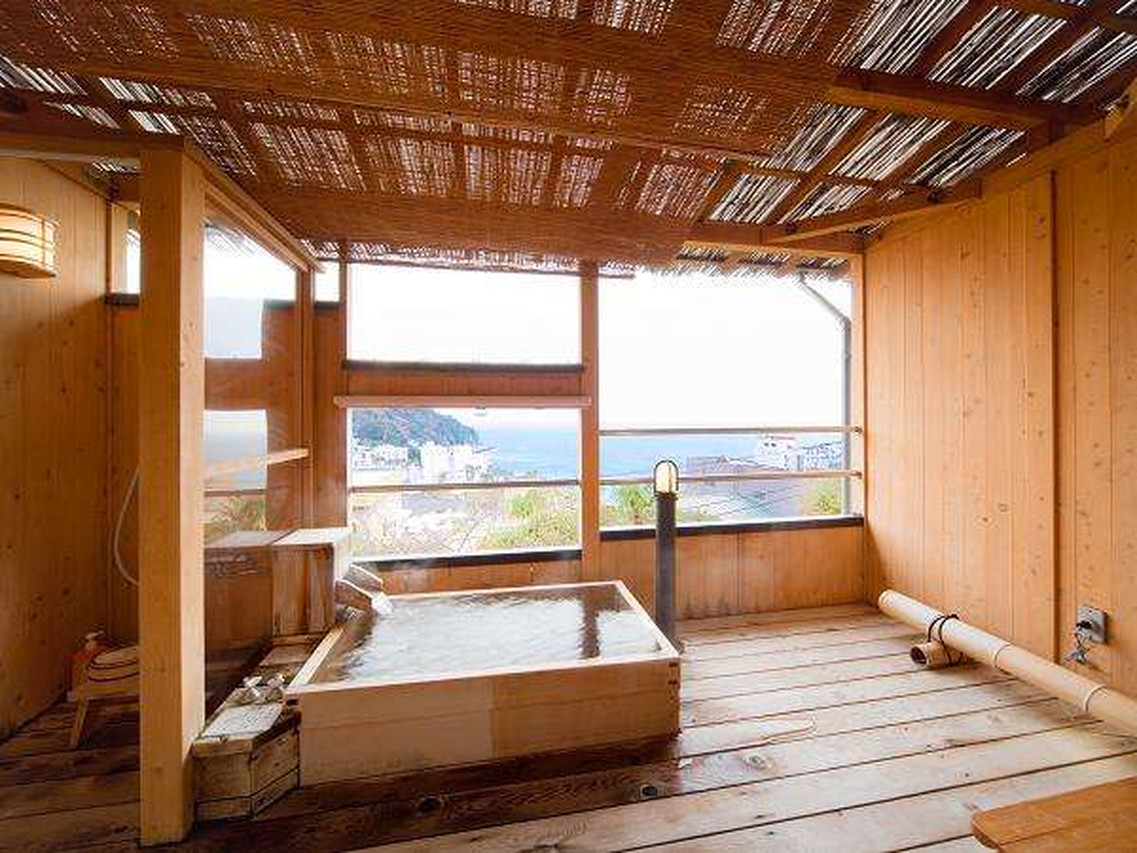 Wood-lined bath with a sea view.