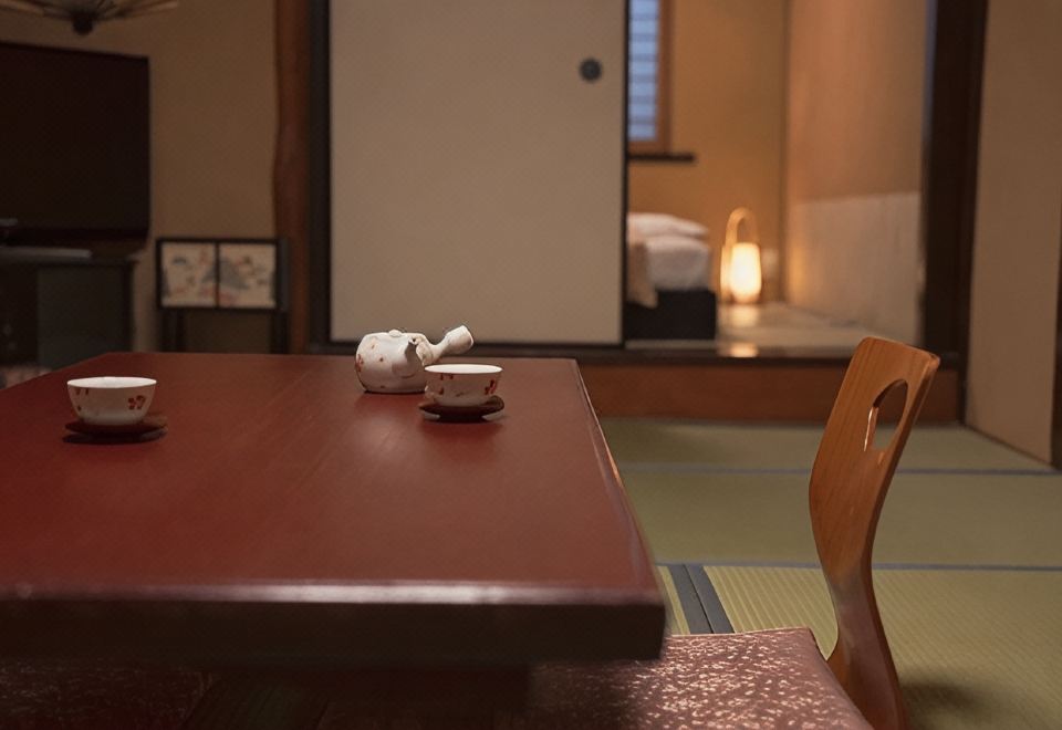 A low table set with a teapot and cups.
