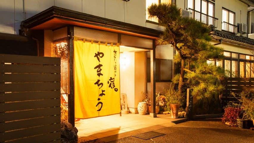 Echizen Crab, Hokuriku Seafood, and Private Bath - Sakana Asobi no Yado Yamachou with a glowing entrance curtain beneath a timber canopy.