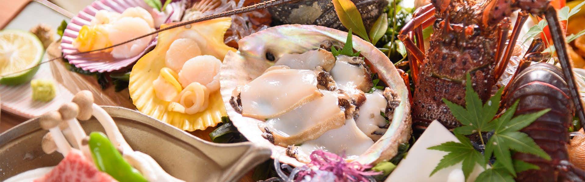 Mokuren with a seafood platter featuring shellfish and colorful vegetables.