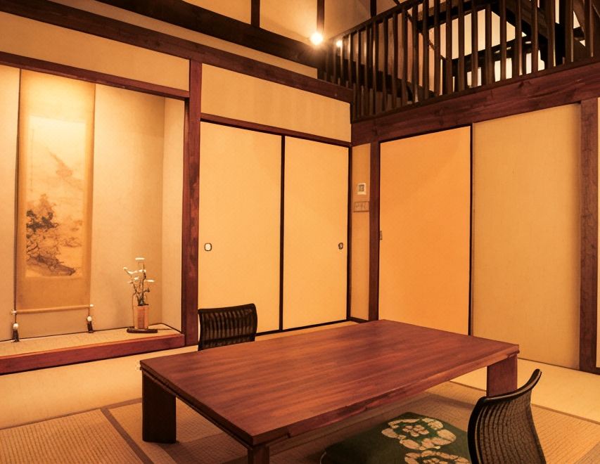 A tatami room with a wooden table and an alcove.