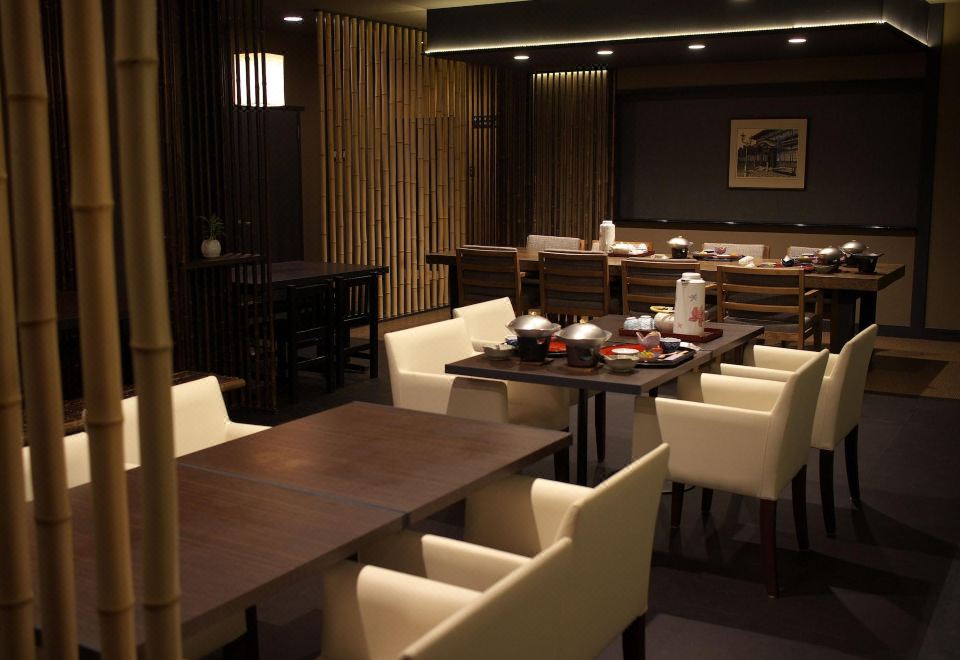 A dining room with tables and chairs.