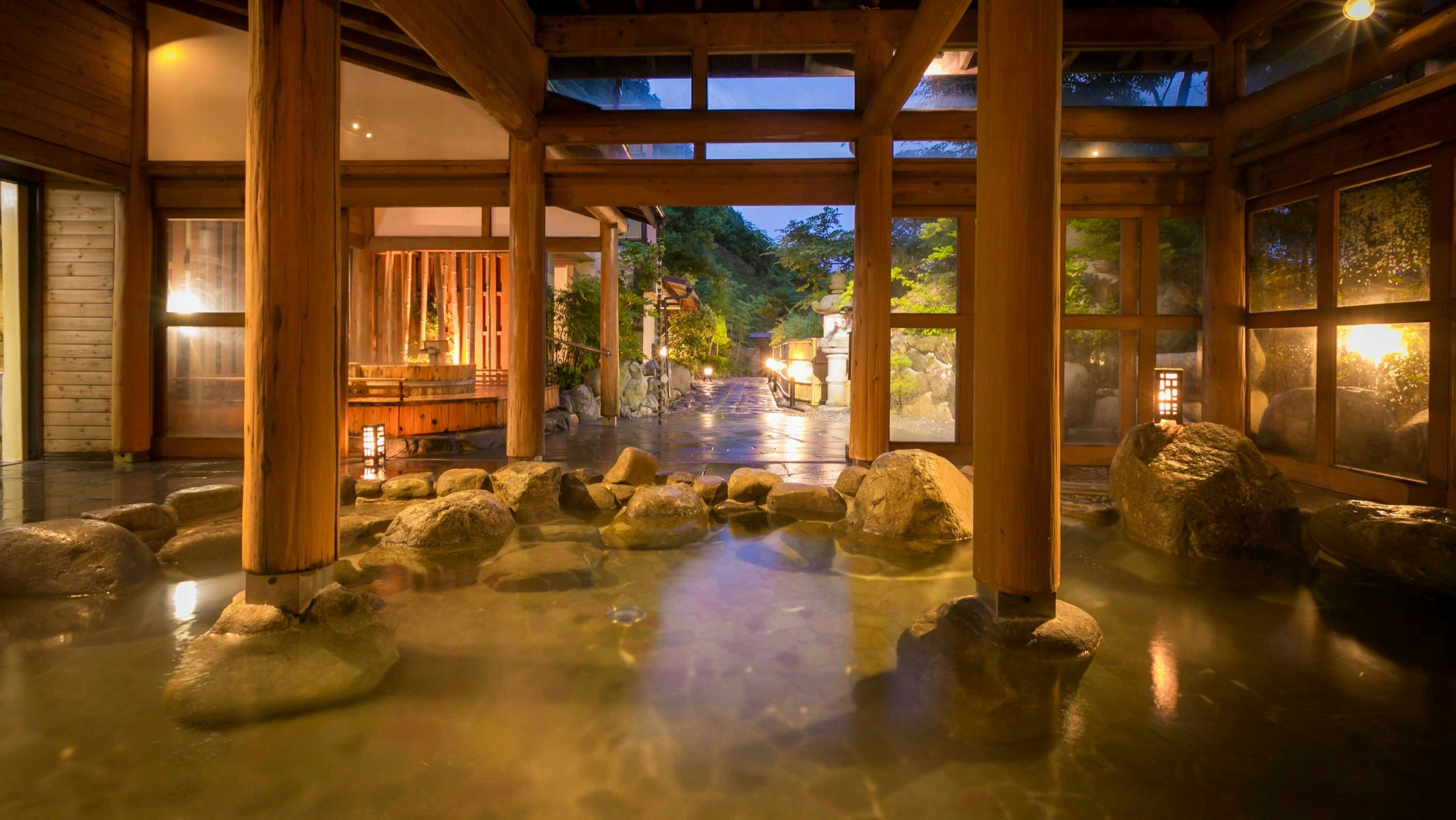 Matsunoya Hanaizumi with a spacious indoor rock bath beneath timber rafters.