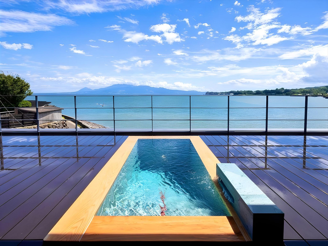 An infinity-edge pool stretches across the seafront terrace.