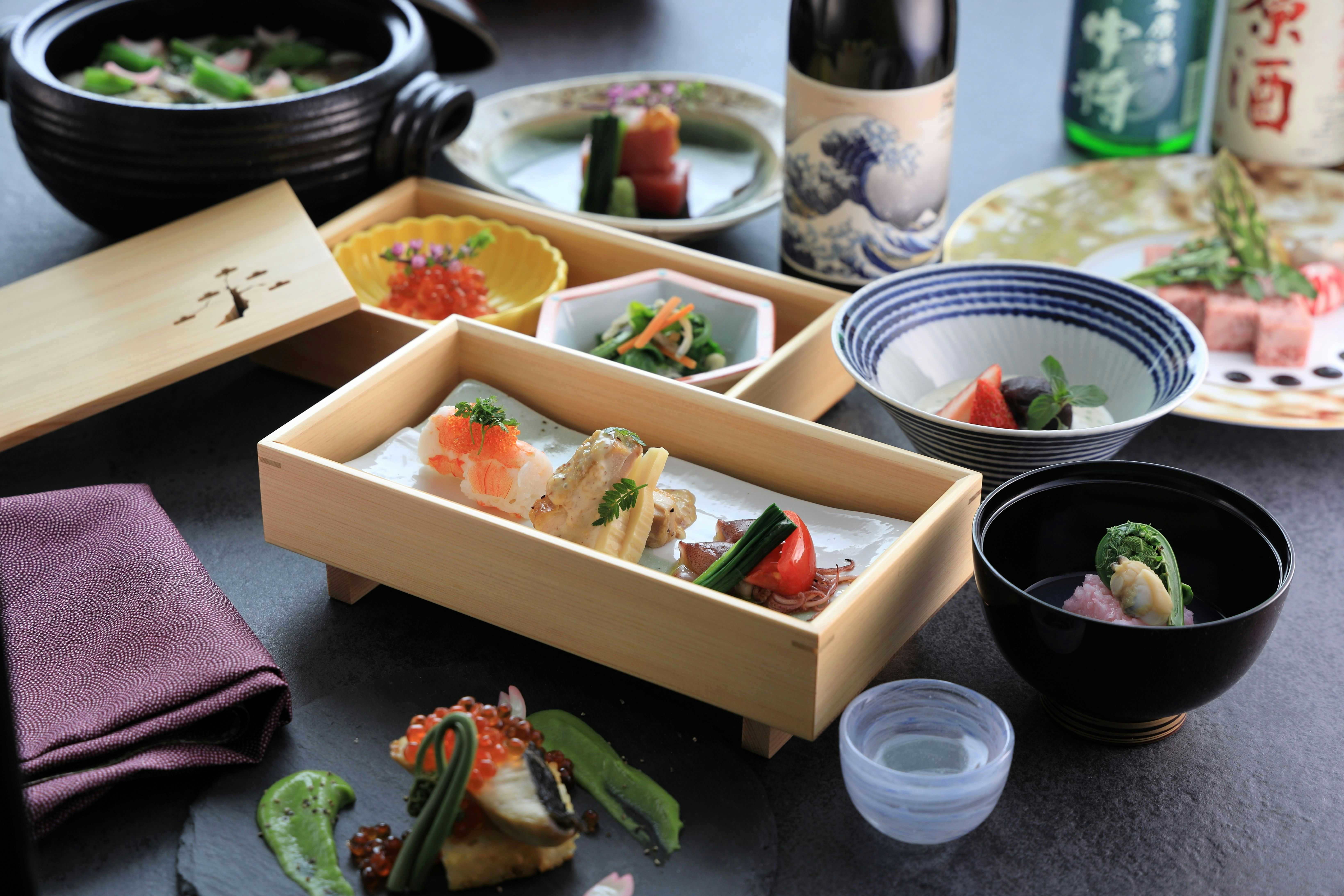 Iizaka Onsen Matsushimaya Momoka with a multi-course meal arranged inside timber boxes and ceramic bowls.