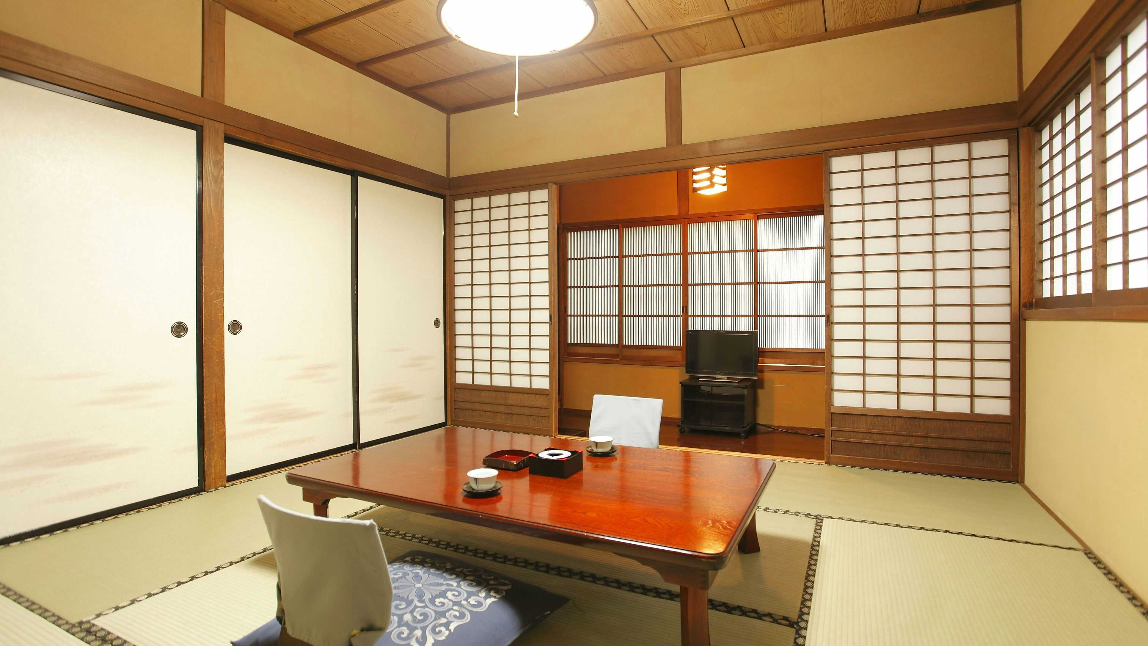 Ryokan Tagoto tatami room with a polished low table, shoji panels and television