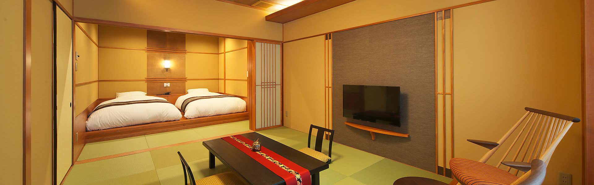Sasayu Inn by the Sea with a tranquil tatami bedroom with low bed and seating.