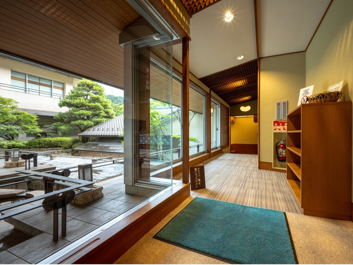 A timber interior opens onto a landscaped courtyard.