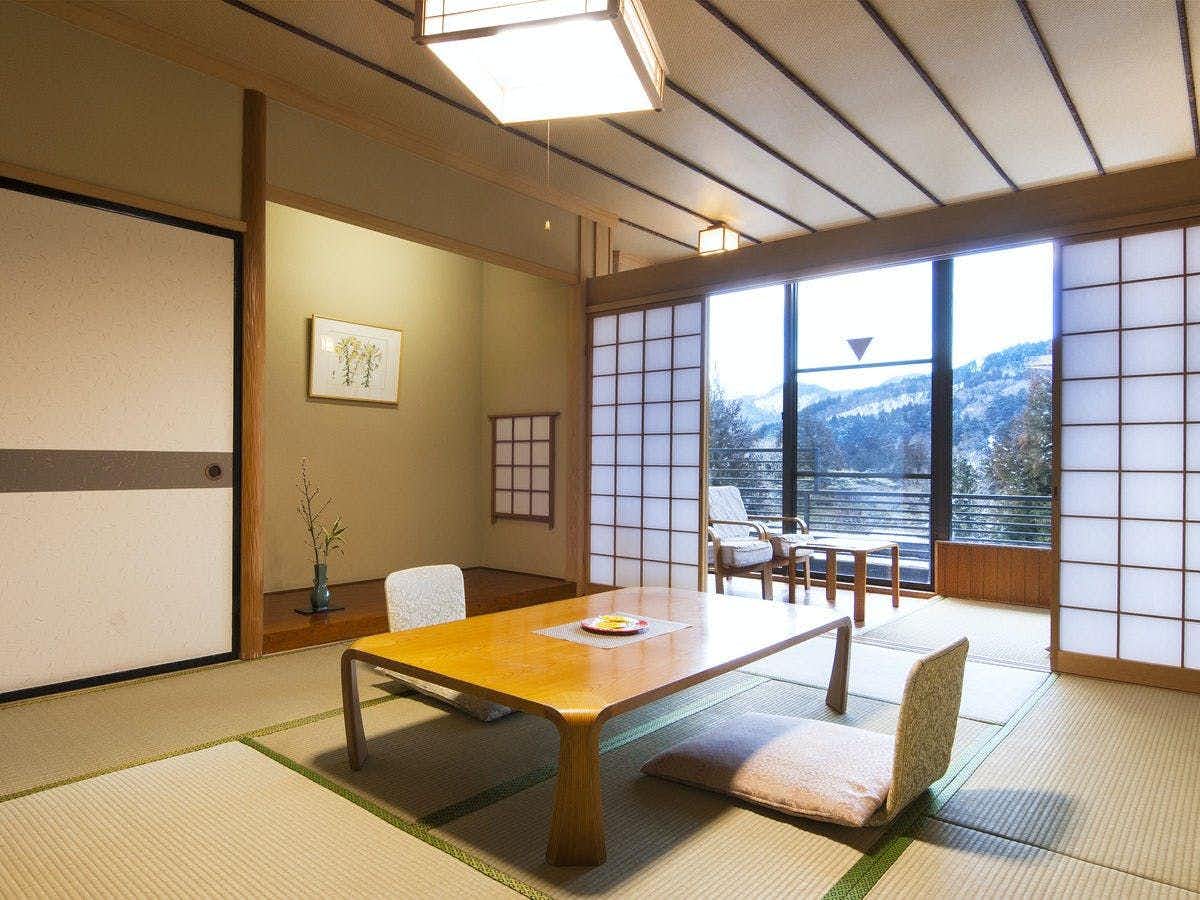 Hotel Seikouen with a traditional tatami room with low table and floor chairs.